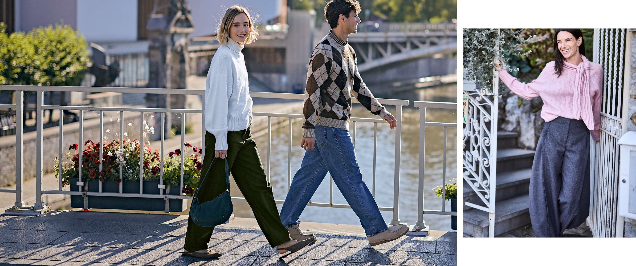 Een vrouw in een witte coltrui en groene broek wandelt op een brug naast een man in jeans en een geruite trui.